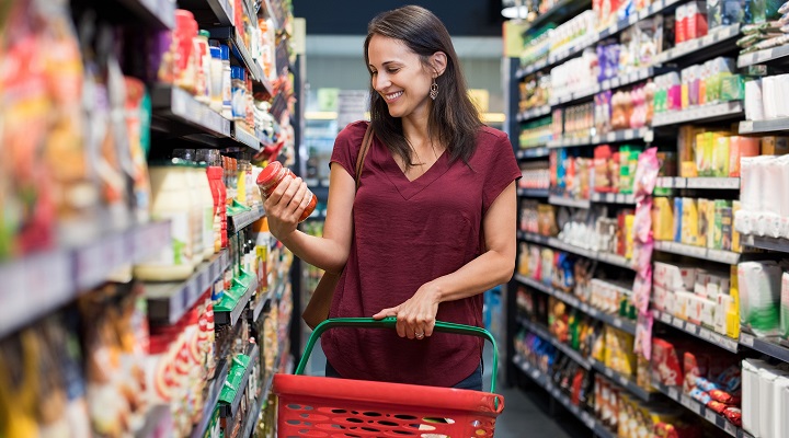 a woman browses for products at a supermarket