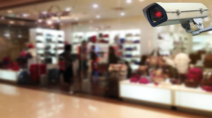 Image of security camera in front of stores.