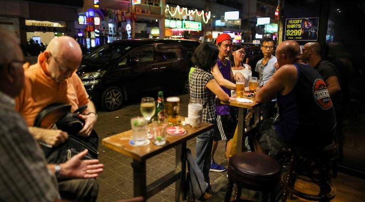 People have a drink inside a bar in Hong Kong