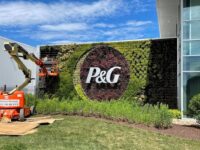 A plant wall with Procter & Gamble logo