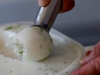 An employee prepares a scoop of ice cream in Saint-Dizier