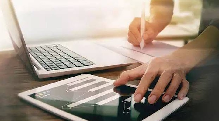 a woman working on laptop and tablet