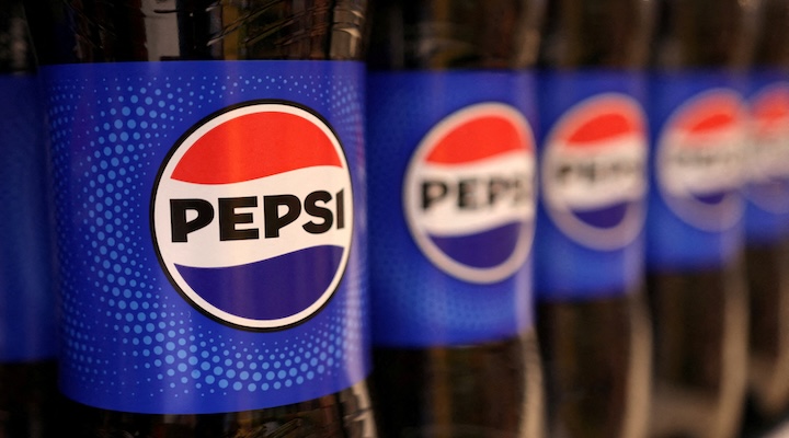 Bottles of Pepsi are displayed on a shelf in a supermarket